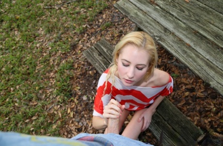 Blonde Odette Delacroix shows her tiny tits while giving a handjob outdoors